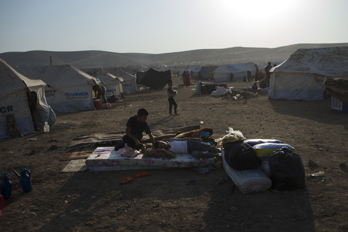 Refugees settle in Kawergost camp outside of Erbil, in northern Iraq. There are now nearly 200,000 Syrian refugees in Iraq, the majority of whom are Kurdish. The large influx—sometimes thousands a day—began when the Kurdistan Regional Government allowed refugees to cross the Tigris River using the reopened Peshkhabour Bridge. Photo by Lynsey Addario, August 23, 2013.