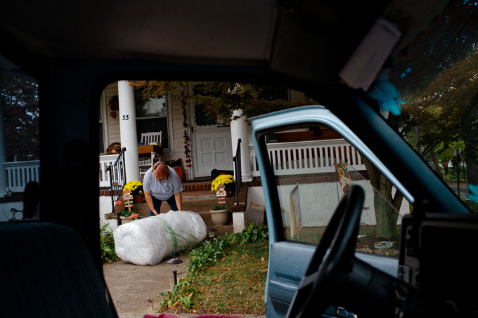 Alyssa Durnien loads bedding into her truck. Although Hurricane Sandy battered the East Coast a year ago, many in Alyssa's town of Keansburg, New Jersey are still reconstructing their homes and lives. Photo by Matt Richter, 2013.