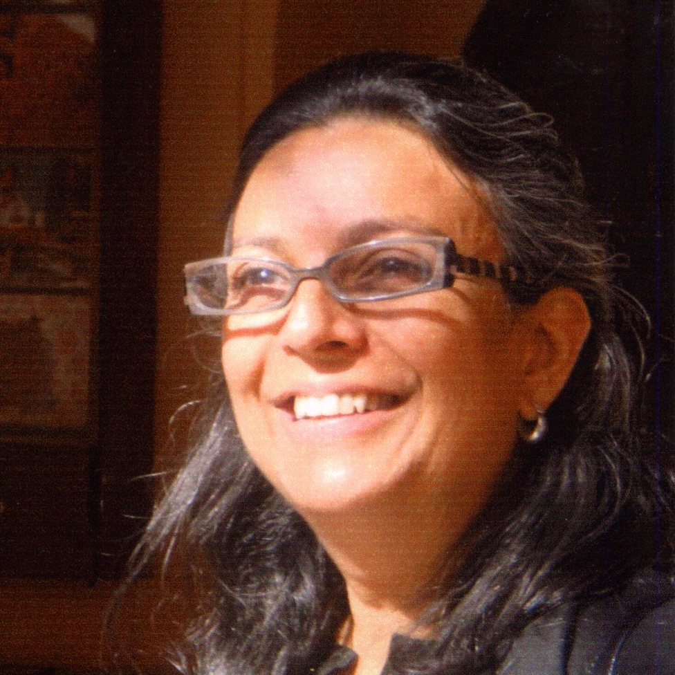 A woman in glasses facing slightly to the left.