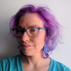 woman with glasses and purple dyed hair. 